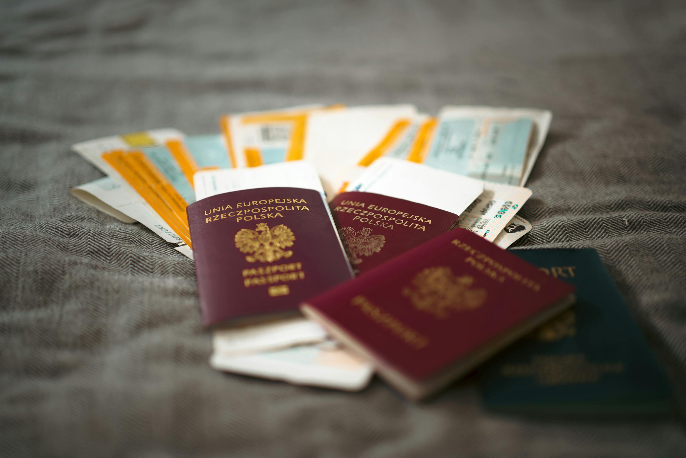 Two passports and travel tickets on a desk, ready for a DS-160 nonimmigrant visa application and consular interview.